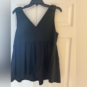 Black babydoll top with bow details. Tuckernuck